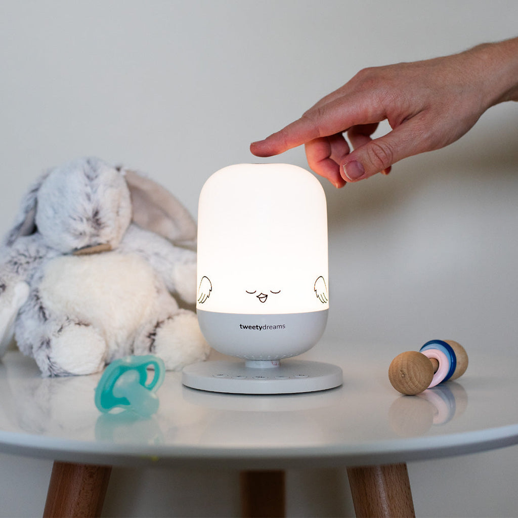 Tweetydreams nightlight sound machine glowing softly in nursery, baby sleep gift for new parents